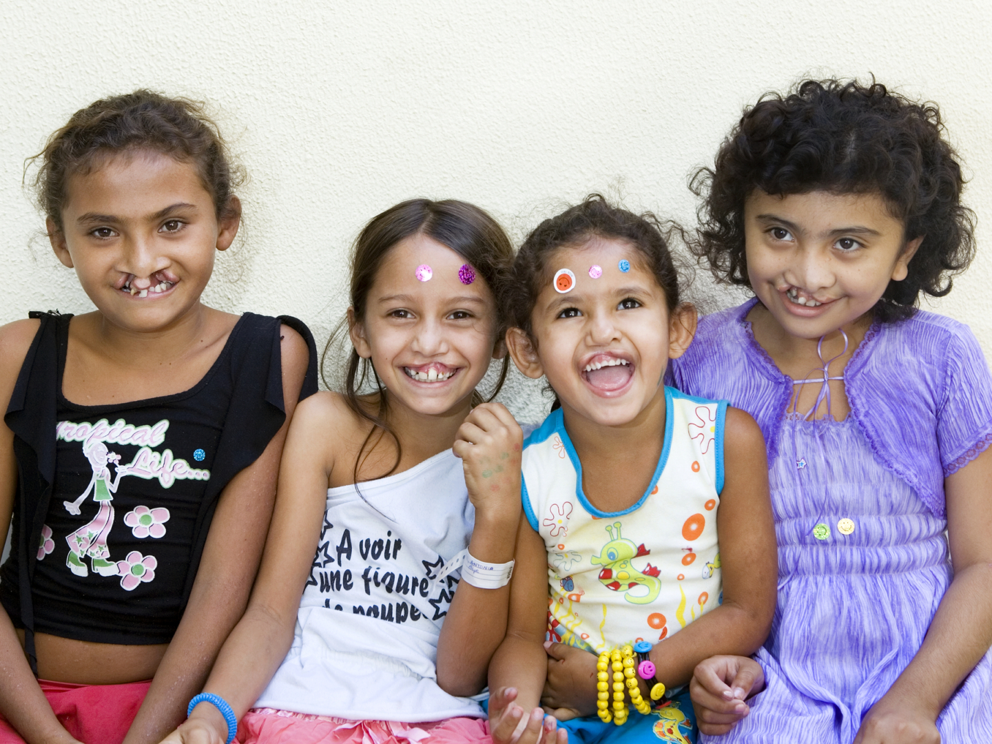 Antonia, pictured second, poses for a photo surrounded by fellow patients and friends during an Operation Smile Brazil surgical program to Fortaleza.