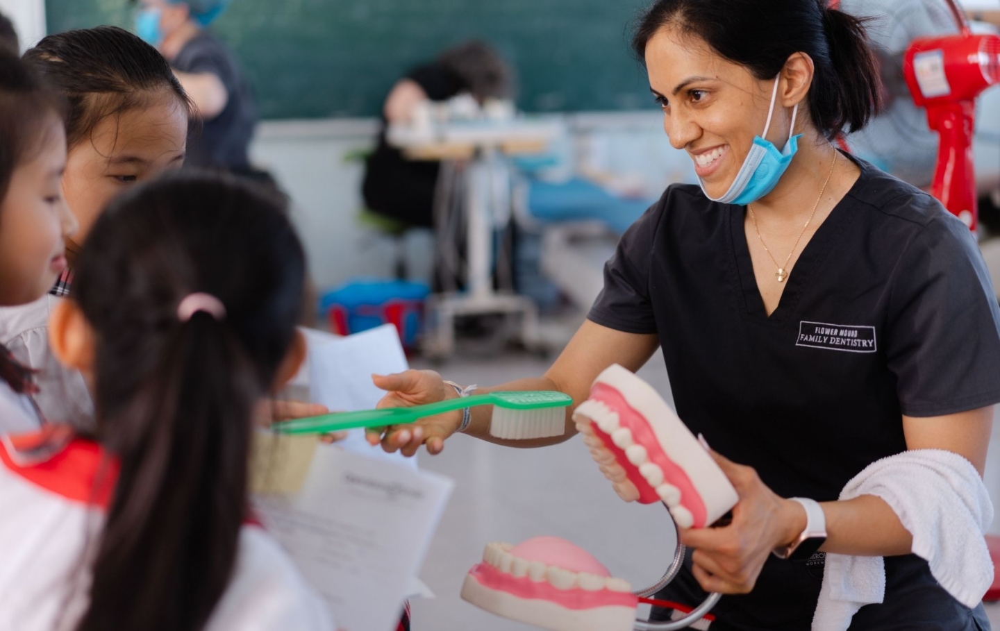 A volunteer shows proper brushing technique during a dental program in Vietnam.