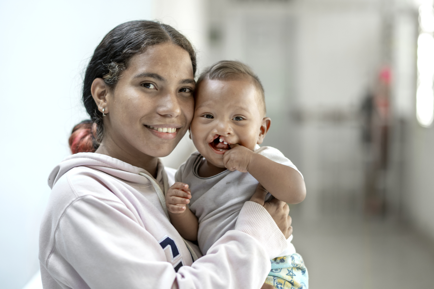 Ihan smiles for the camera with his mother, Carla.