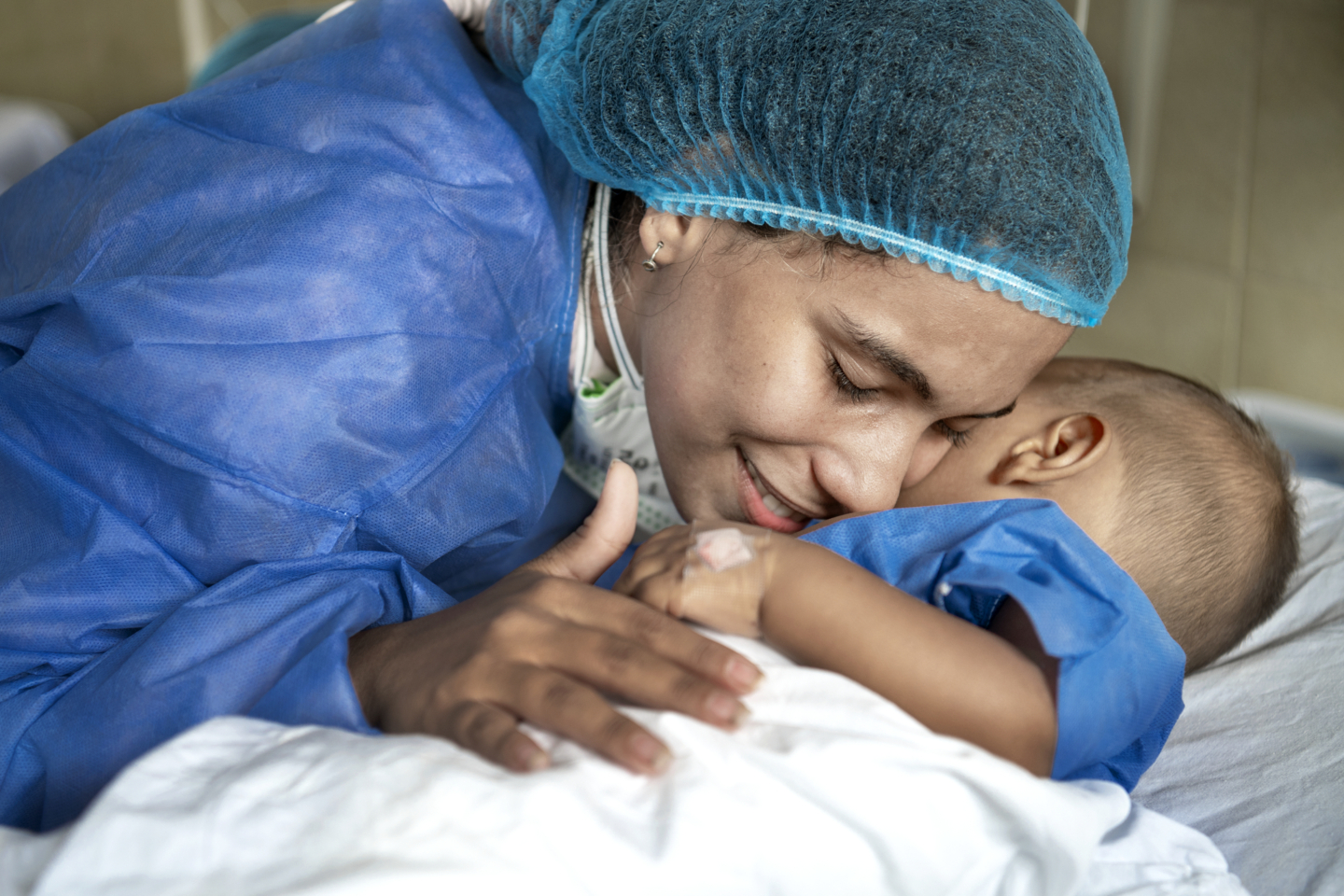 Carla snuggles with Ihan after surgery.