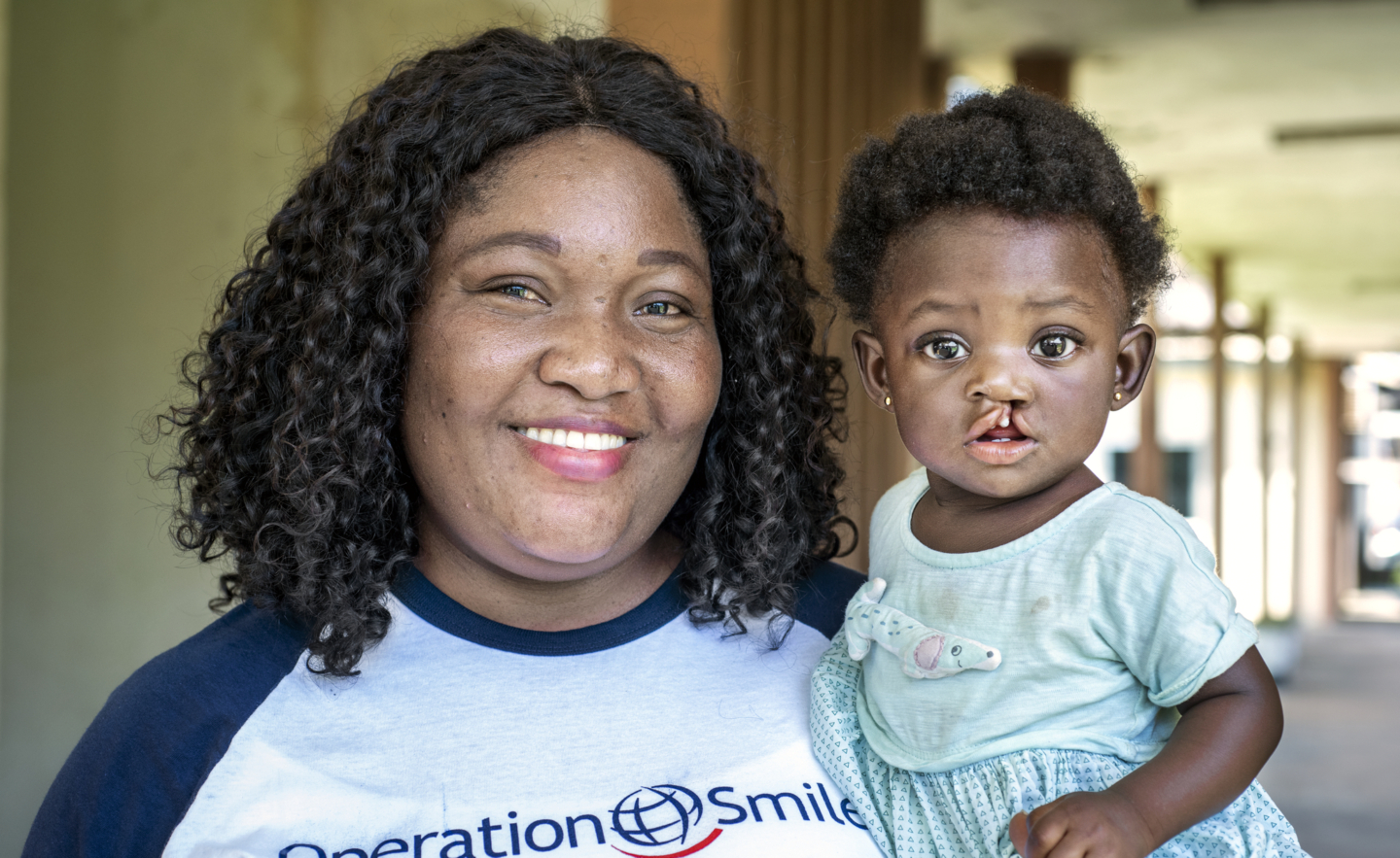 Irene Dzirasa smiles while holding 9-month-old Selina.