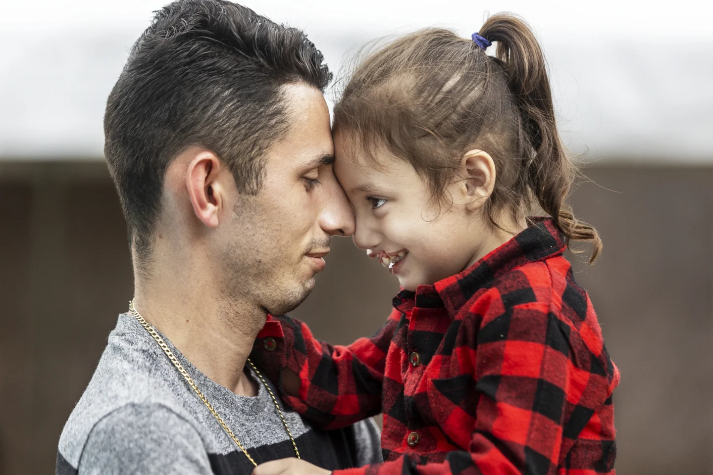 A father and daughter share a moment during a surgical program.