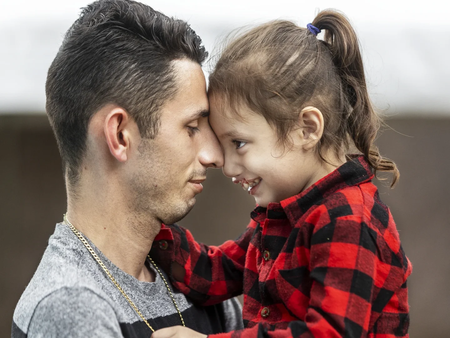 A father and daughter share a moment during a surgical program.