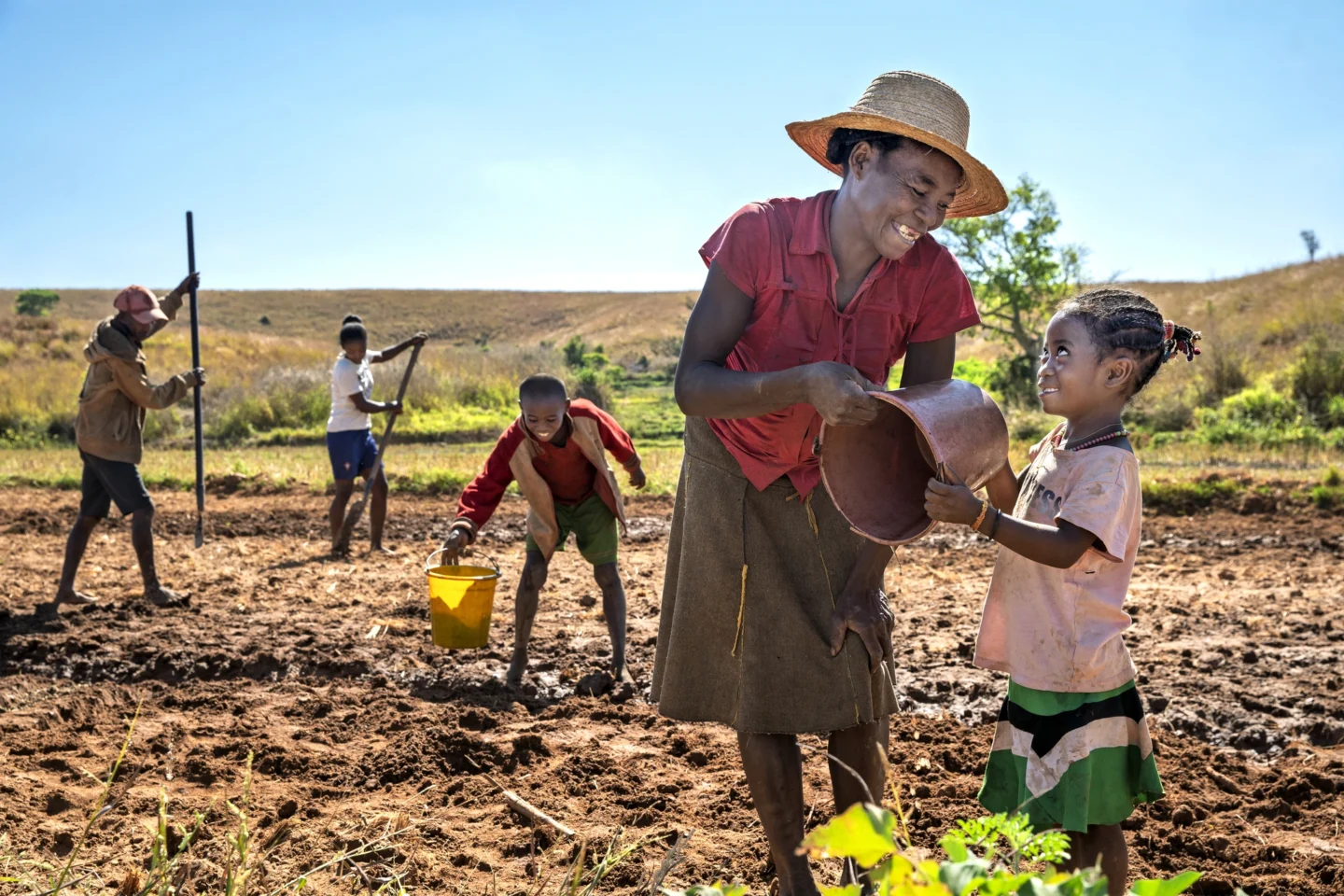 Leana and her community work while smiling for the camera.