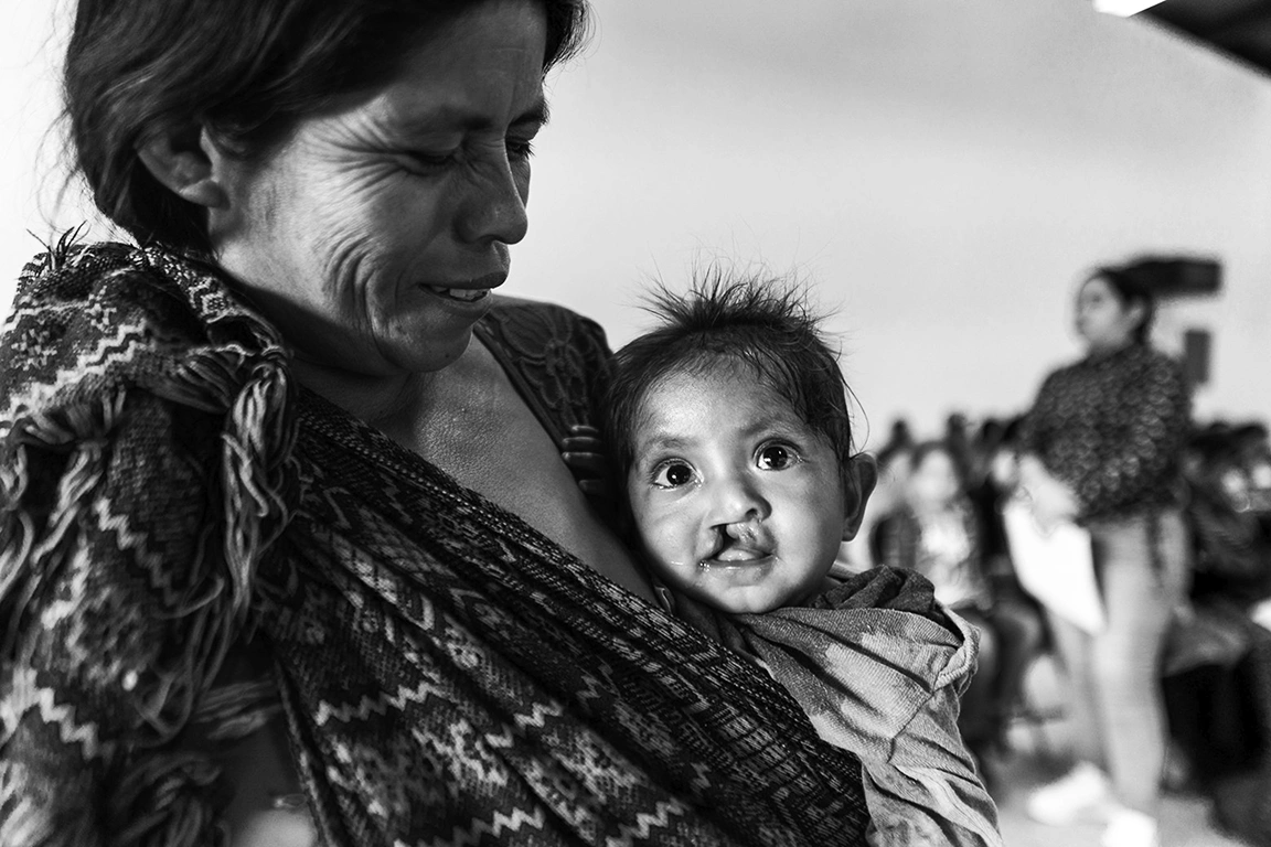 A mother and baby smile for the camera.