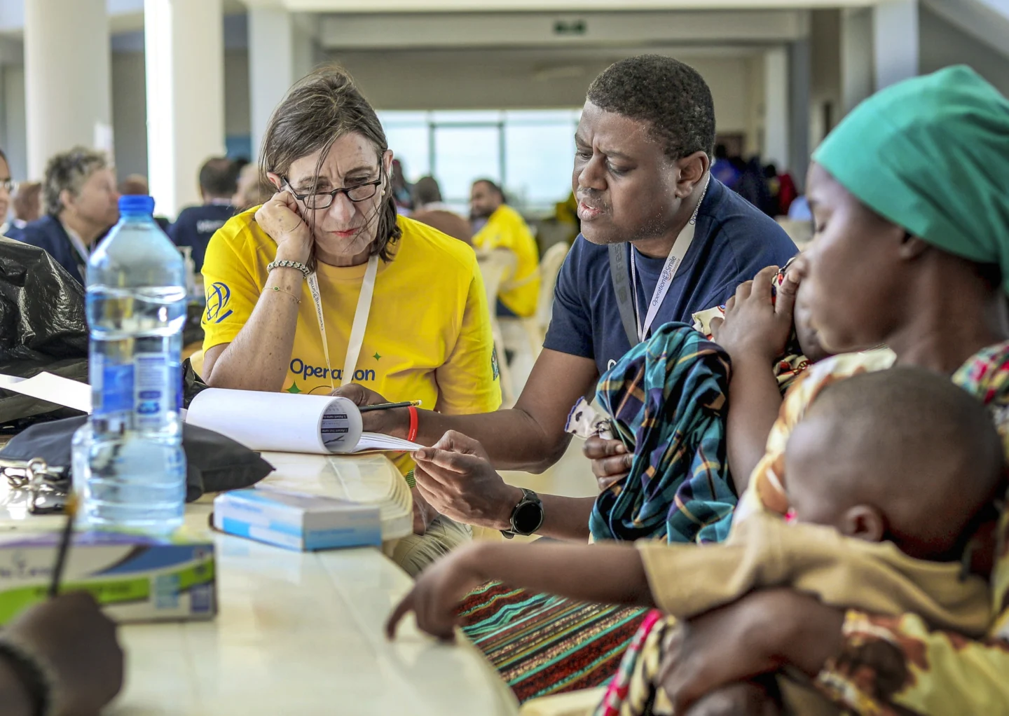 Volunteers review paperwork during a surgical program in Tanzania