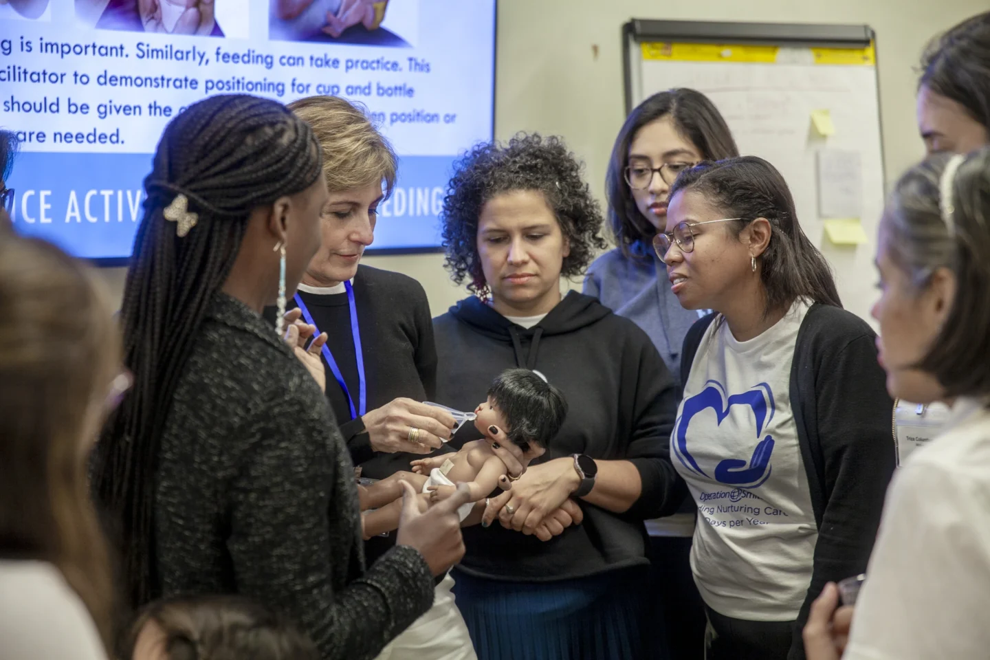 Health care providers discuss feeding techniques.