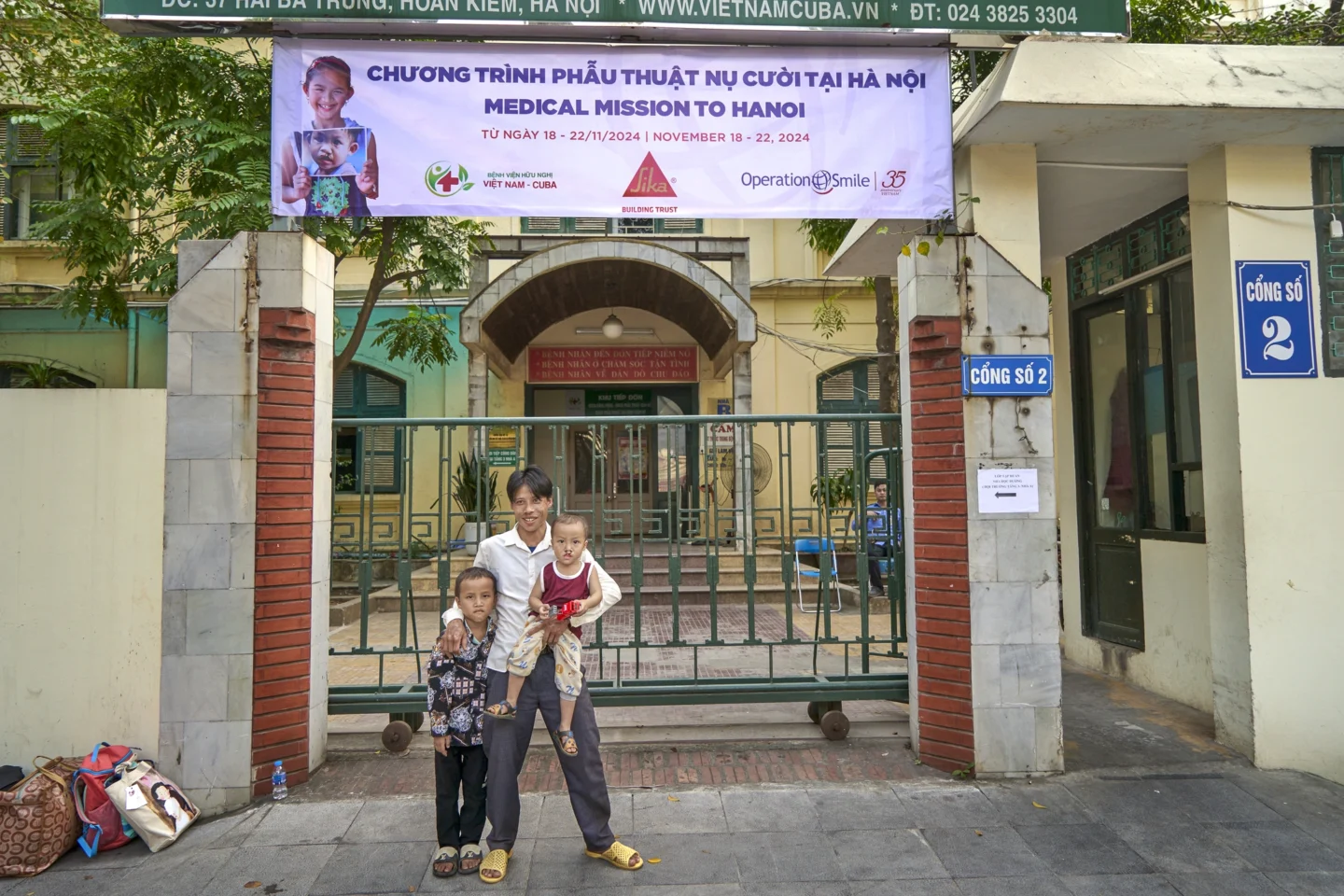 Phuc and his family stand outside of the Operation Smile program site.