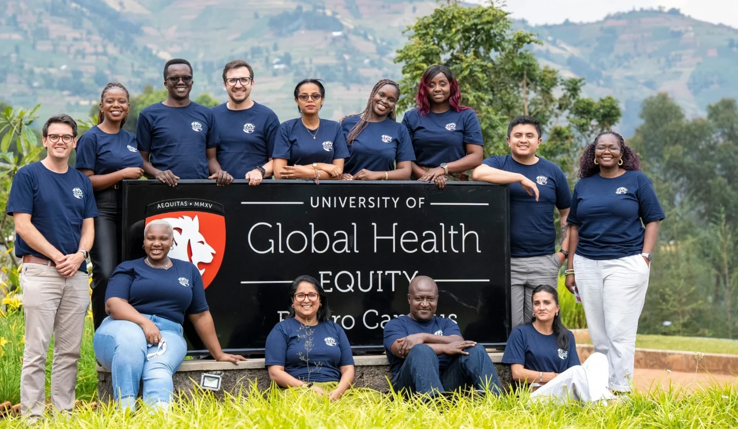 Global Surgery Advocacy Fellows pose for a photo near a sign.