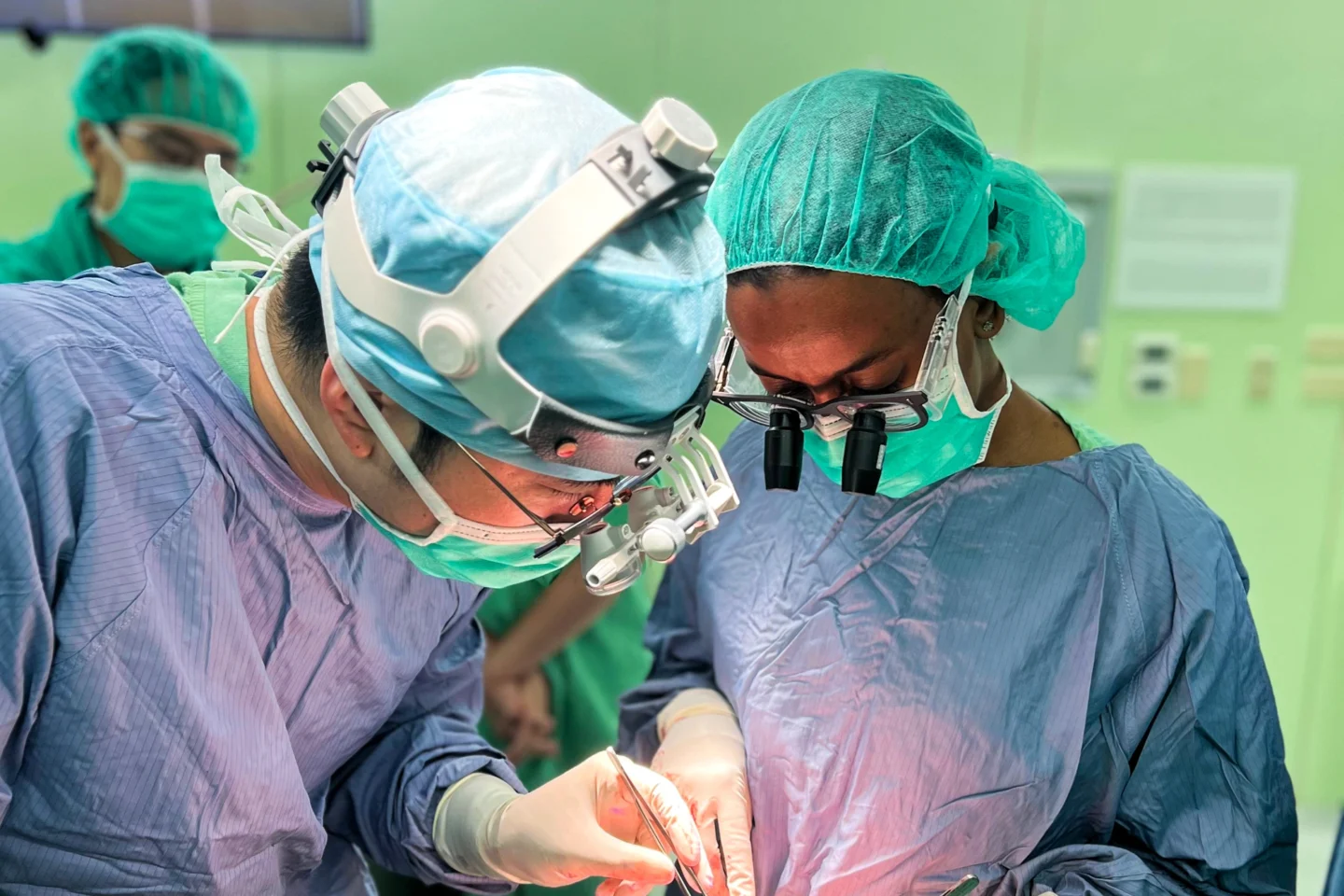 Surgeons provide care to a patient.