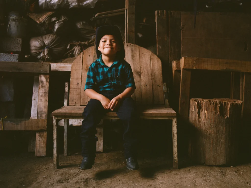 Junior Jeremias sits on a bench.
