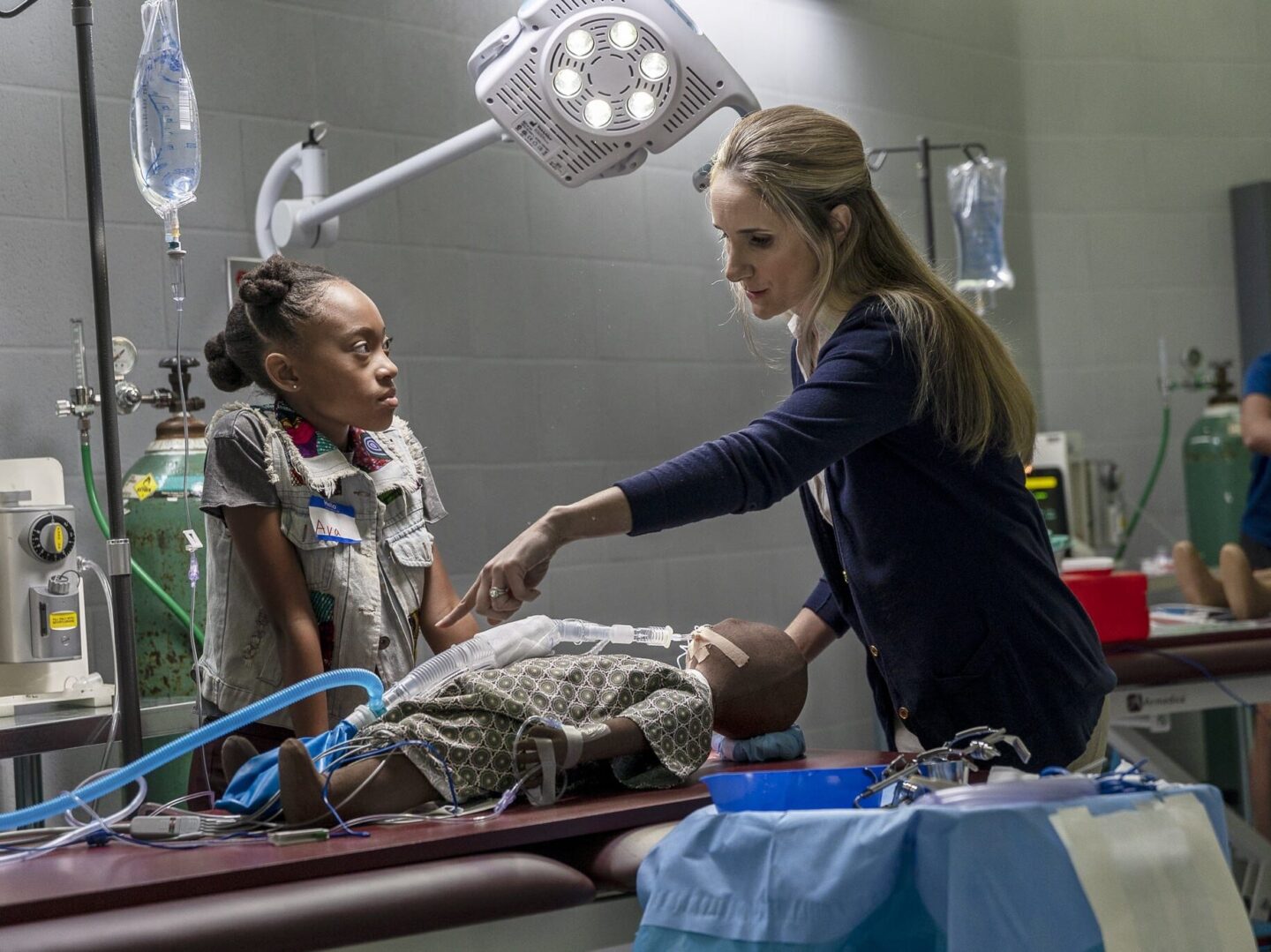 A women shows a child something during a tour of the Interactive Learning Center.