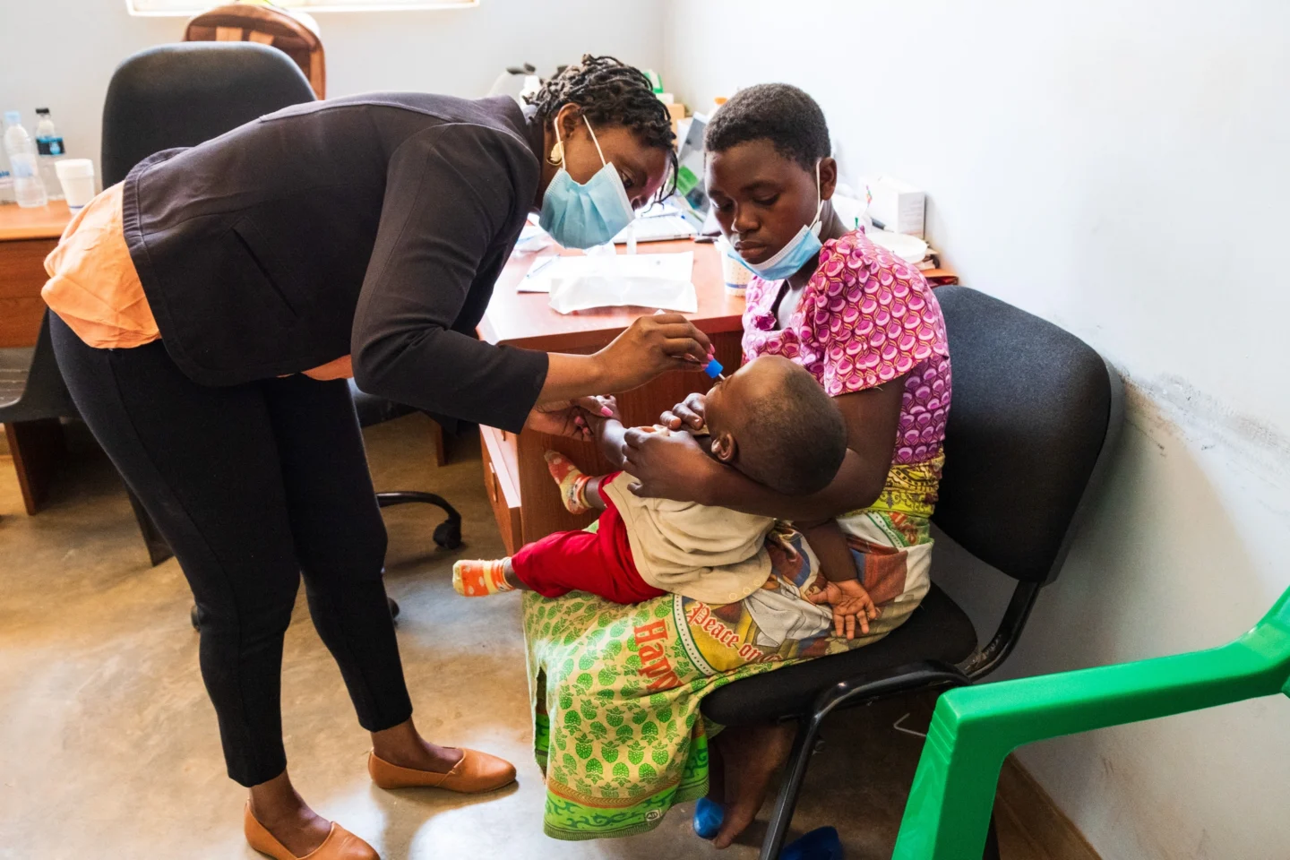 Five-year-old Michael sits patiently as Sharon, a plastic surgeon resident, takes a DNA sample.