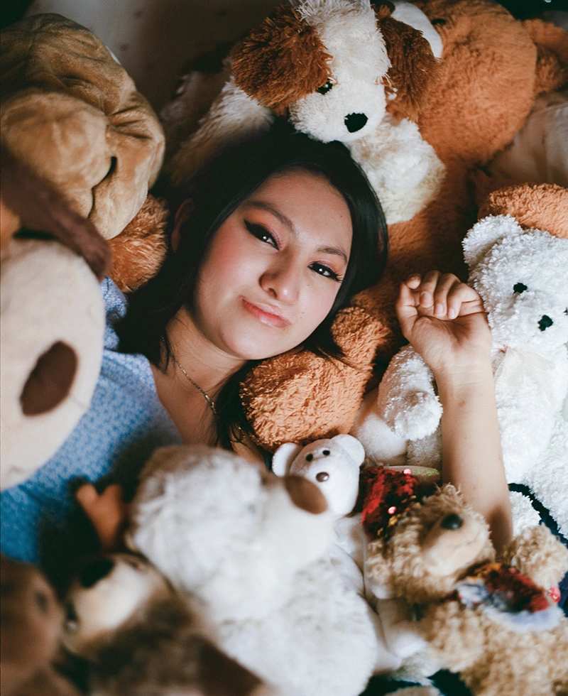 Palisha, surrounded by her stuffed animals given to her by Operation Smile