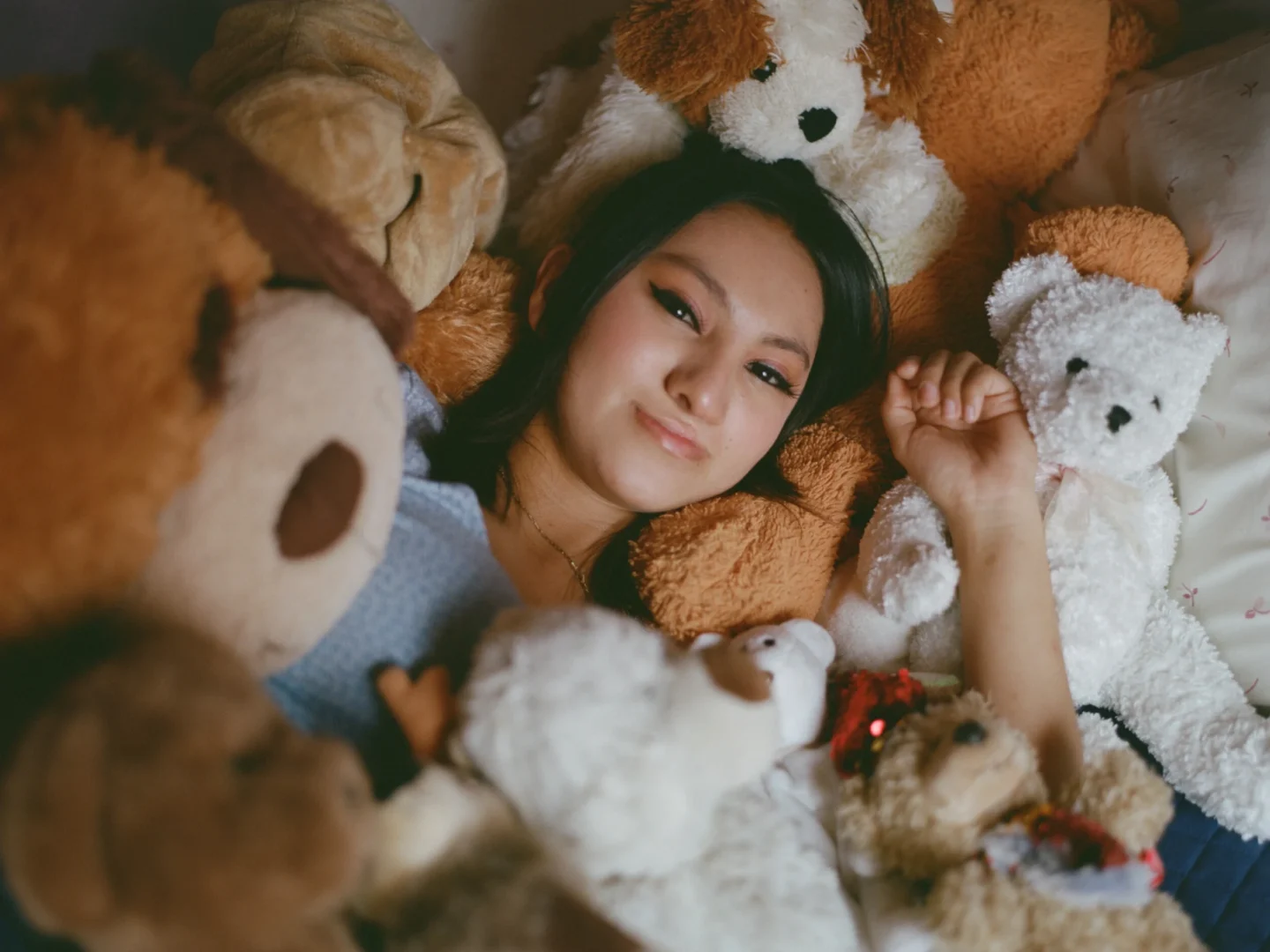 Palisha, among the stuffed animals she's received from Operation Smile over the years.