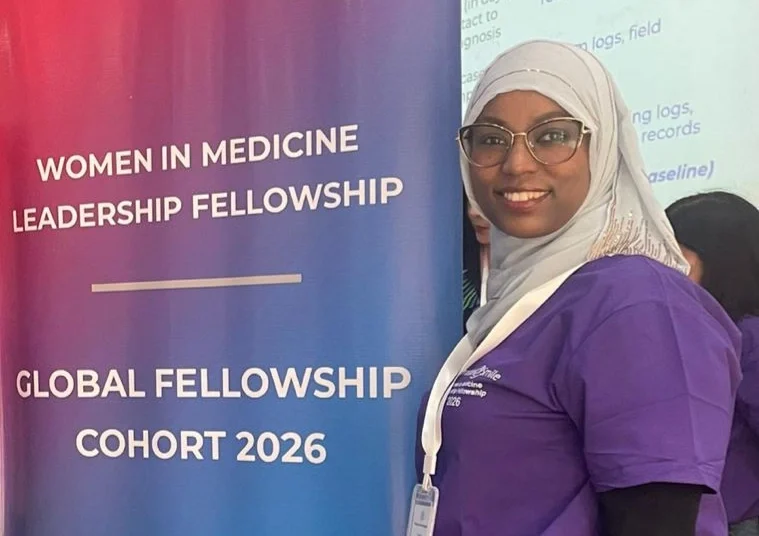 Dr. Fetiya Awol poses with a banner.
