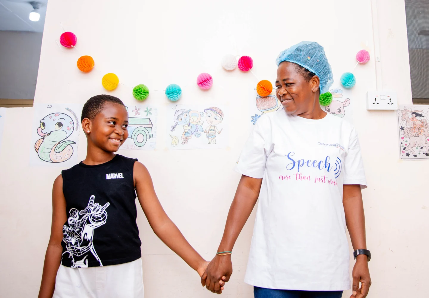 A volunteer and patient hold hands during a program.