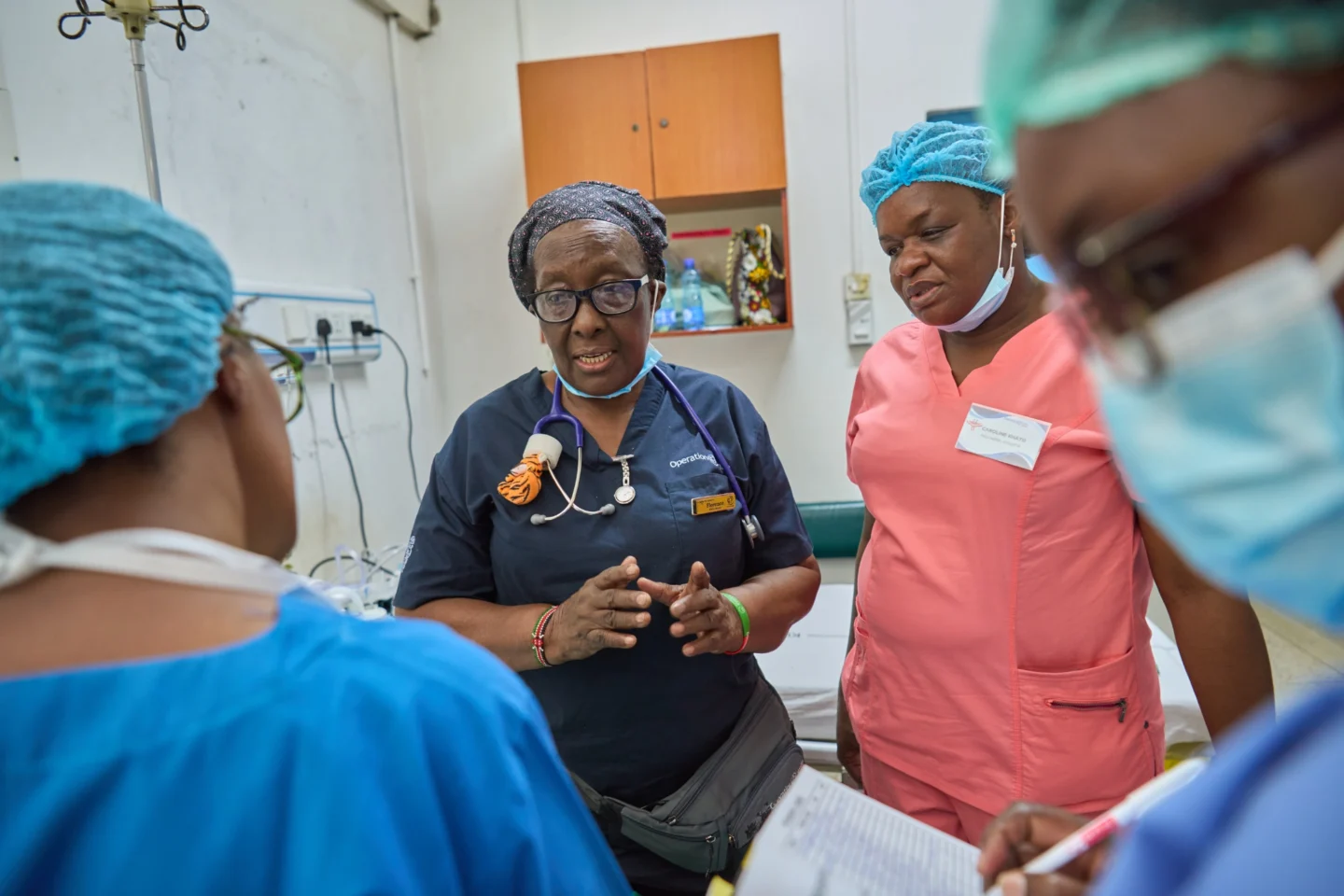 A nurse speaks with her colleague