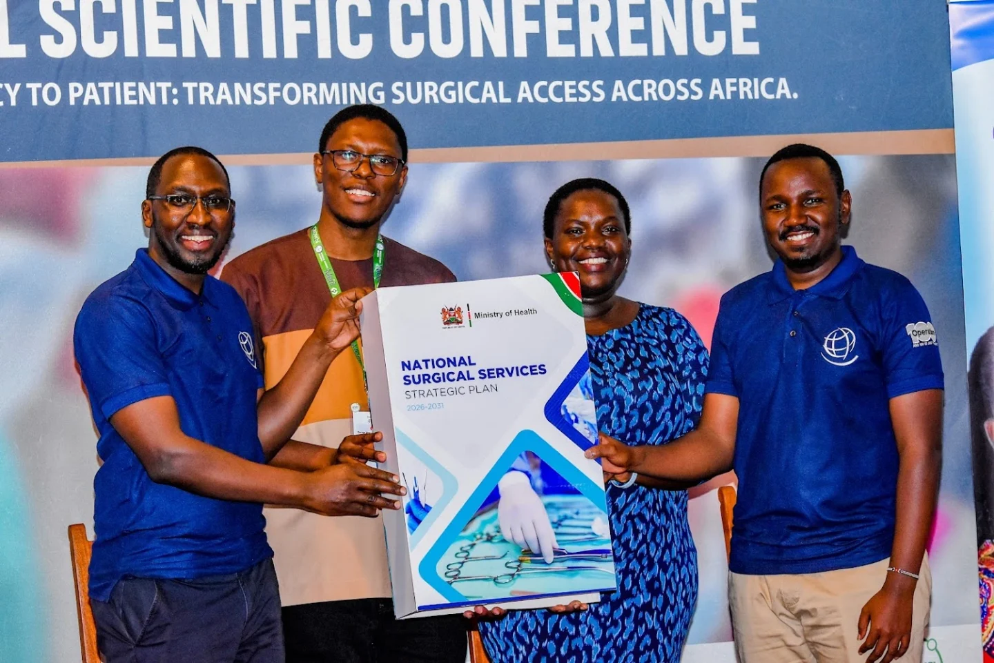 The team smiles holding the an enlarged version of the Kenya NSOAP.