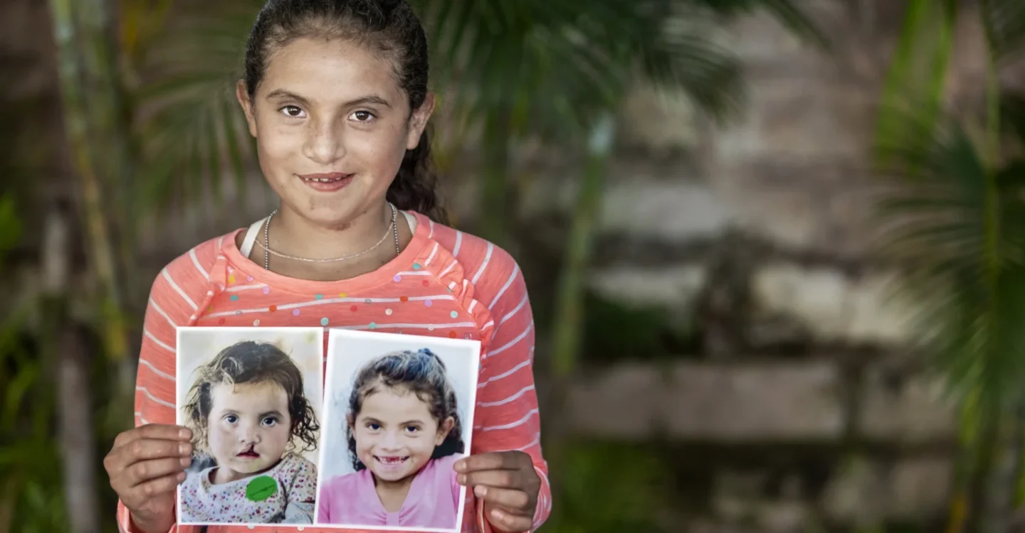 Yitci holds two photos of her when younger.