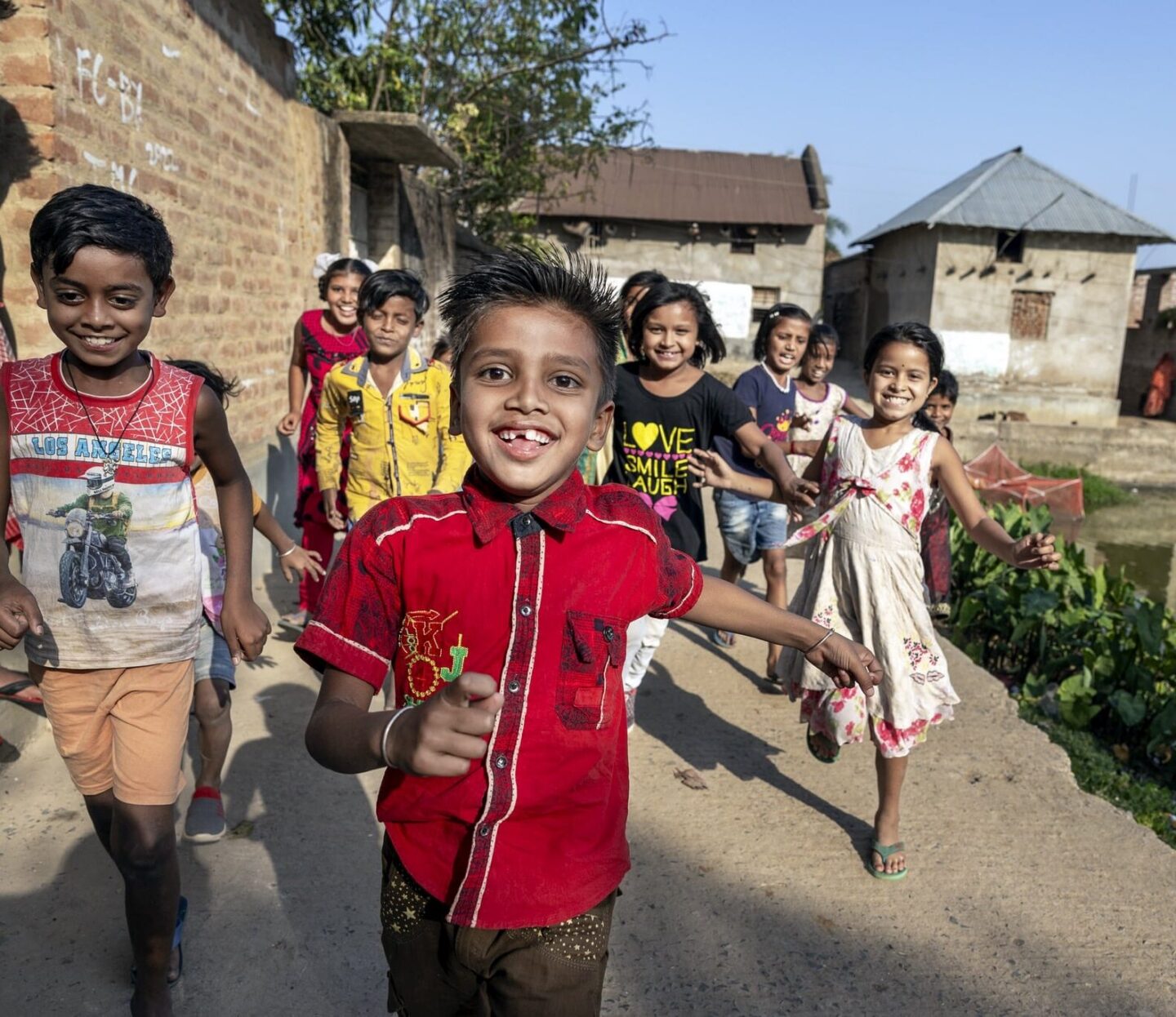 Shyam runs towards the camera with friends.