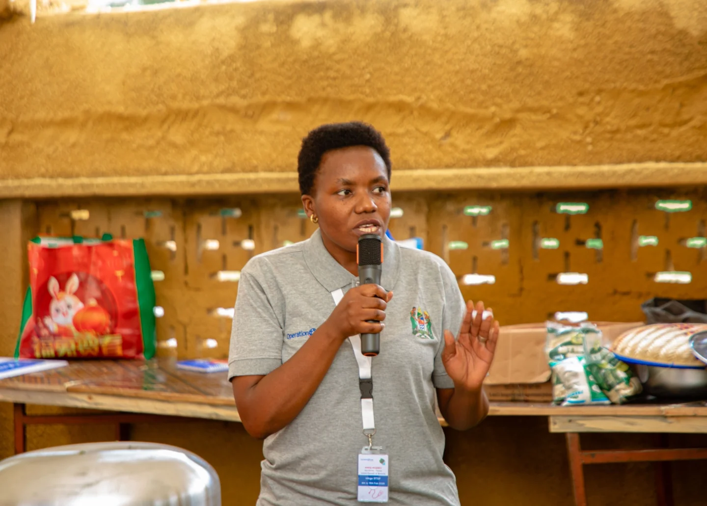 Anna Nombo, Operation Smile volunteer, holds a microphone