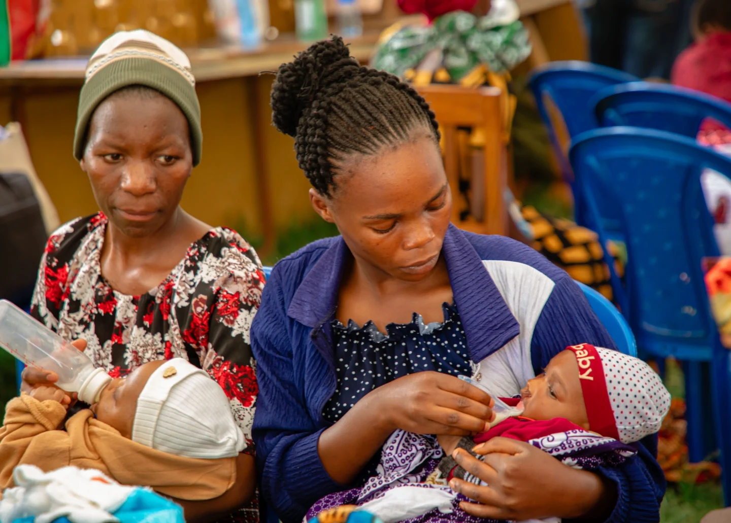 Mothers at a program feed their children.