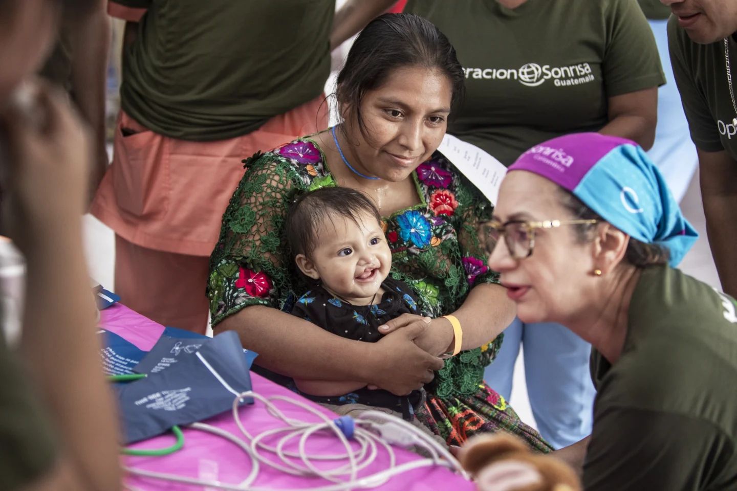 Volunteers speak with a patient and her family