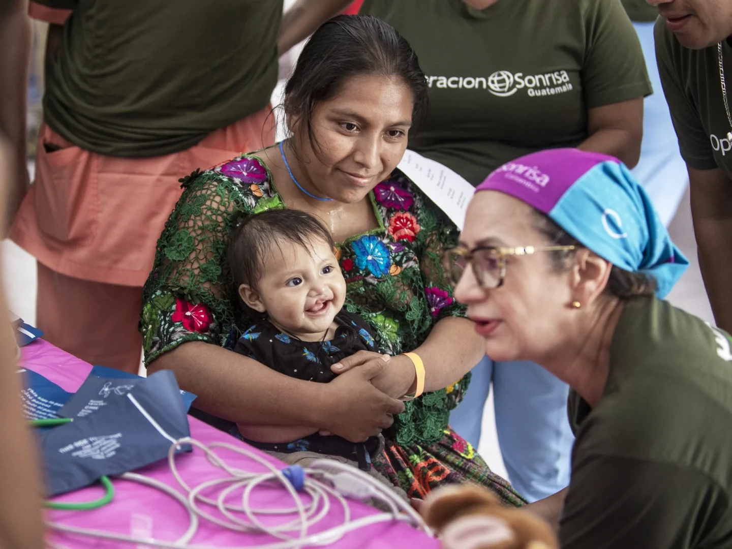 Volunteers speak with a patient and her family