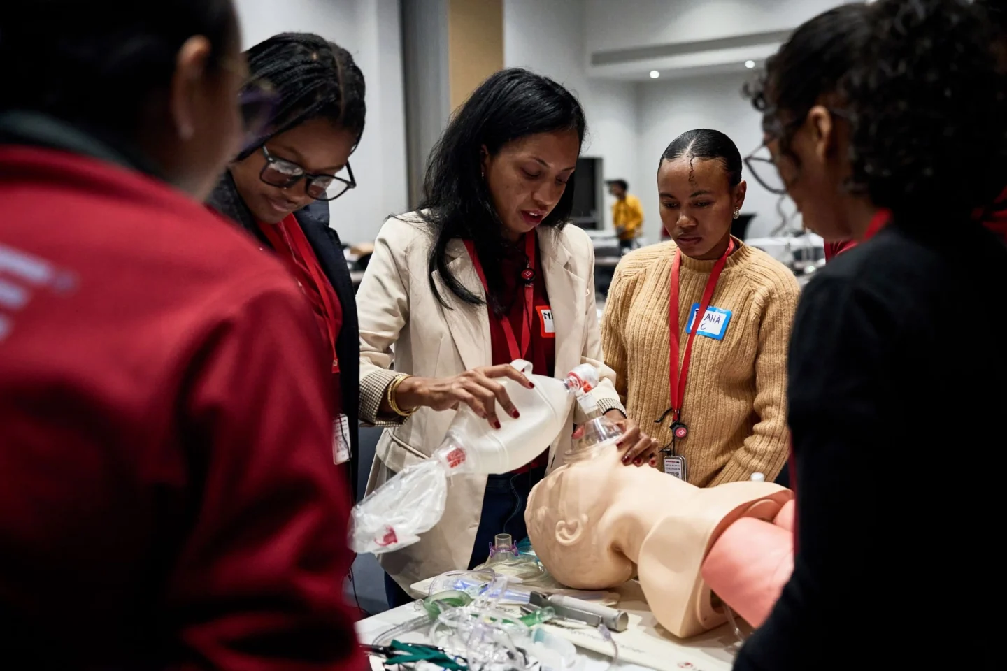 A group of women anesthesia providers in Madagascar during a training demonstration with a training dummy.